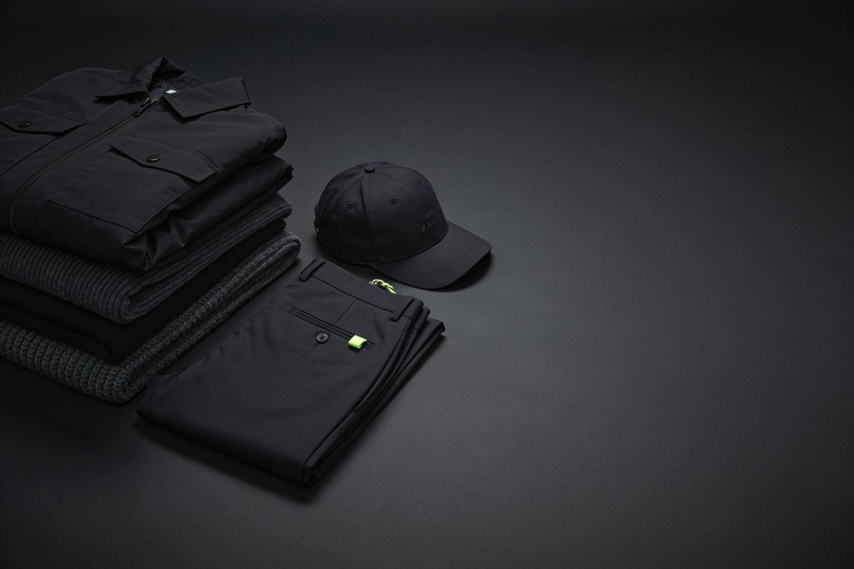 Curated Korean brand apparel - folded outerwear, knitwear, trousers and a cap offered to verified buyers