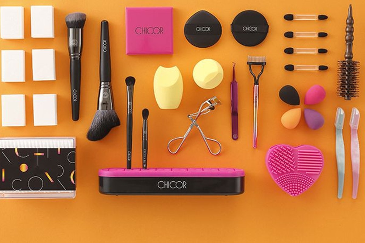 Representative lot of Korean beauty tools - makeup brushes, blending sponges, an eyelash curler, tweezers, a brush cleaning pad and a round brush