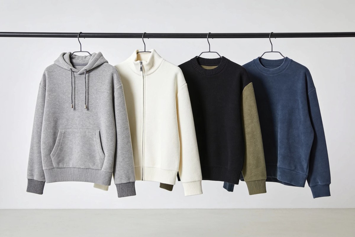 Representative lot of F/W hoodies and sweatshirts - grey fleece hoodie, cream zip-neck, black crew and navy crew sweatshirt on a rail