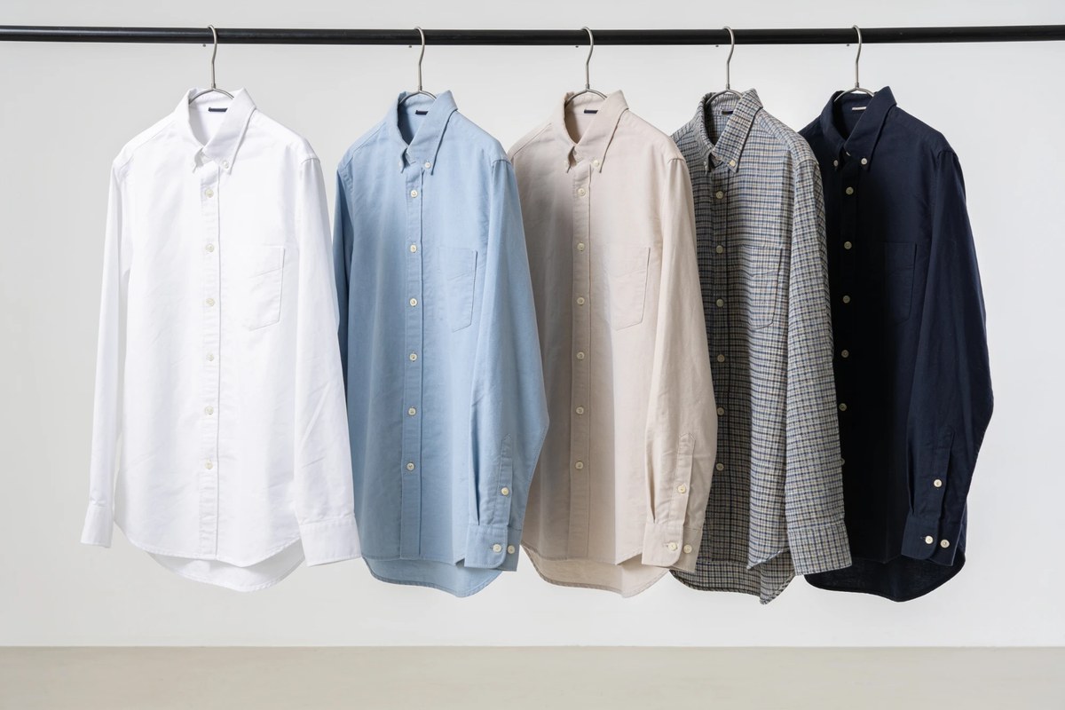 Representative lot of oxford and casual shirts - white, blue and beige button-downs with a check and a navy shirt on a rail